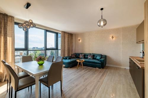 a living room with a table and a couch at Metalex Garden 2bdrm Luxury Apartment in Varna City