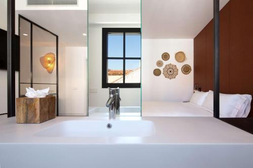 a bathroom with a sink and a mirror at Atocha Hotel Madrid, Tapestry Collection by Hilton in Madrid