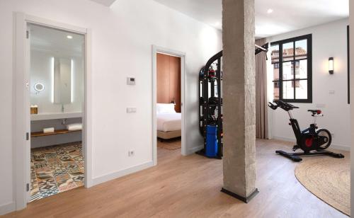 a room with a room with a bed and a exercise bike at Atocha Hotel Madrid, Tapestry Collection by Hilton in Madrid