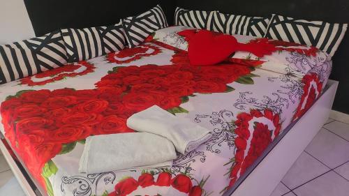 a bed with a bunch of red roses on it at L'angolo dei sogni in Acitrezza