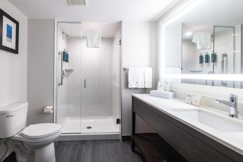 a bathroom with a toilet and a sink and a shower at DoubleTree by Hilton Calgary North in Calgary