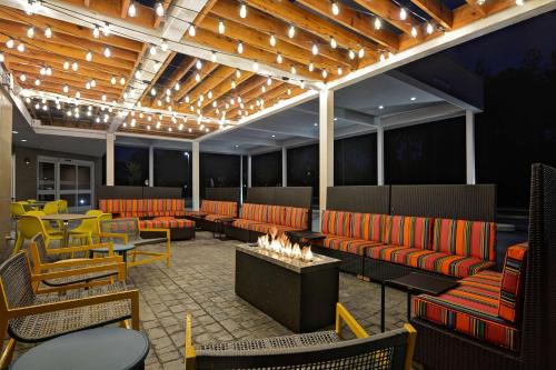 a restaurant with orange couches and a fire pit at Home2 Suites By Hilton Fort Mill, Sc in Fort Mill