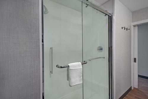 a shower with a glass door in a bathroom at Hampton Inn Midland South, Tx in Midland