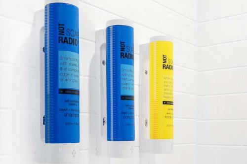 four blue and yellow thermometers hanging on a wall at Tru By Hilton Dallas Market Center in Dallas