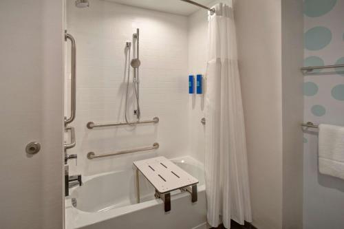 a bathroom with a shower and a tub and a sink at Tru By Hilton Concord, Nh in Concord