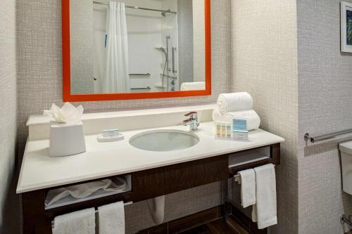 a bathroom with a sink and a mirror at Hampton Inn & Suites Indio, Ca in Indio