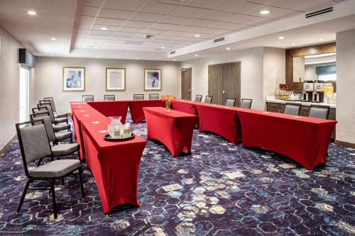 a conference room with a long red table and chairs at Hampton Inn & Suites Indio, Ca in Indio