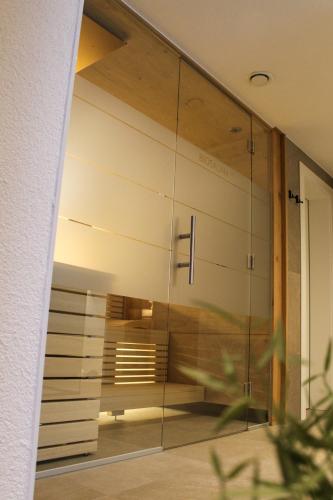 a glass wall in a house with a view of a room at Apart Austria in Nauders
