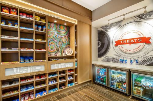 a food section of a store with food items on shelves at Hampton Inn & Suites Raleigh Midtown, NC in Raleigh