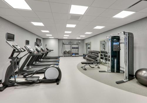 a gym with a row of treadmills and machines at Hampton Inn by Hilton Irvine Spectrum Lake Forest in Lake Forest