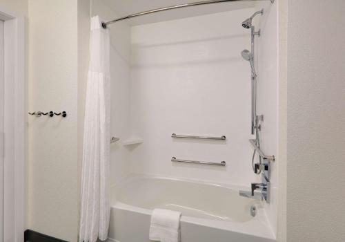 a white bathroom with a tub and a shower at Hampton Inn by Hilton Irvine Spectrum Lake Forest in Lake Forest