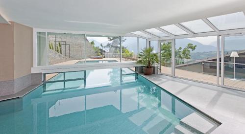 una piscina en una casa con paredes de cristal en Hotel Schennerhof, en Scena