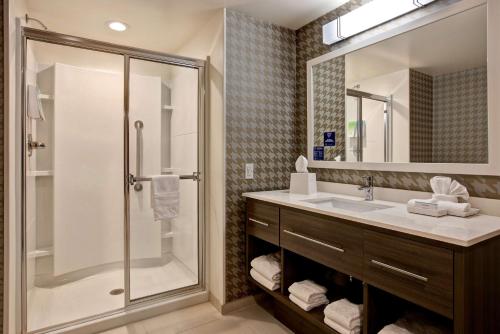 a bathroom with a shower and a sink at Home2 Suites By Hilton Carmel Indianapolis in Carmel