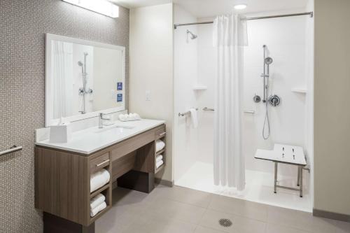 a bathroom with a sink and a shower at Home2 Suites By Hilton Cape Canaveral Cruise Port in Cape Canaveral