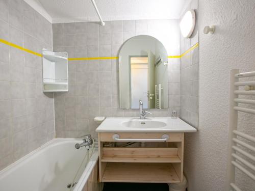 a bathroom with a sink and a tub and a mirror at Appartement Val-d'Isère, 4 pièces, 6 personnes - FR-1-694-139 in Val-d'Isère