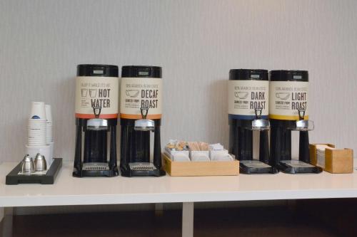 a shelf with four bottles of wine on it at Hampton Inn & Suites Charlotte North I 485 in Charlotte