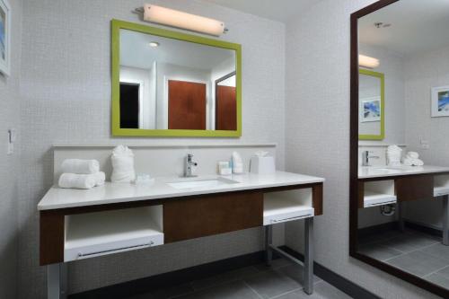 a bathroom with a sink and a mirror at Hampton Inn & Suites Charlotte North I 485 in Charlotte