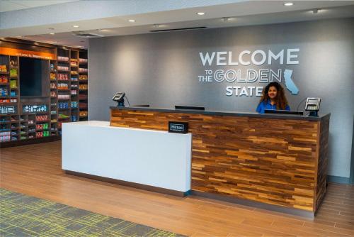 a woman standing behind a counter in a store at Hampton Inn & Suites Imperial Beach San Diego, Ca in Imperial Beach