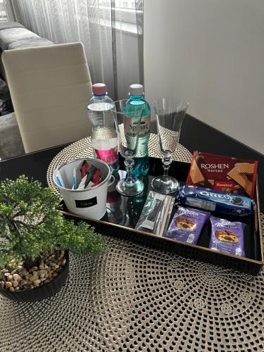a table with a tray of food and drinks on it at Luxurious Accommodation in Floreşti