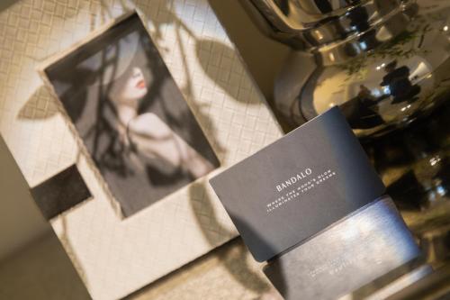 a picture of a woman on a counter with a card at Bandalo Boutique Hotel - Patong Beach Road in Patong Beach
