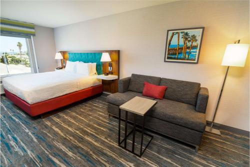 a hotel room with a bed and a couch at Hampton Inn & Suites Imperial Beach San Diego, Ca in Imperial Beach