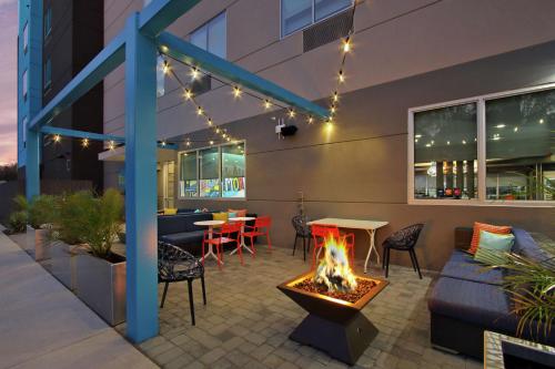 a patio with a fire pit and a table and chairs at Tru By Hilton Waco South in Waco
