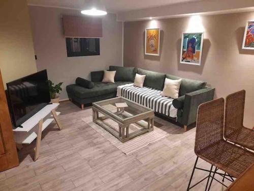 a living room with a couch and a coffee table at cozy studio in cite ennasr 1 in Ariana