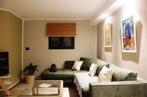 a living room with a couch and a table at cozy studio in cite ennasr 1 in Ariana