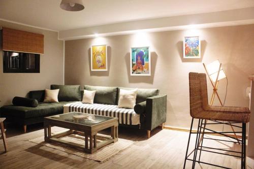 a living room with a couch and a table at cozy studio in cite ennasr 1 in Ariana