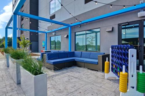 a lobby of a building with a blue couch at Tru By Hilton Fort Mill, Sc in Fort Mill