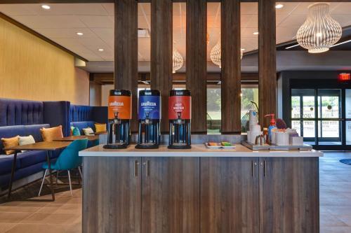 a bar with three bottles of wine on top of it at Tru By Hilton Fort Mill, Sc in Fort Mill