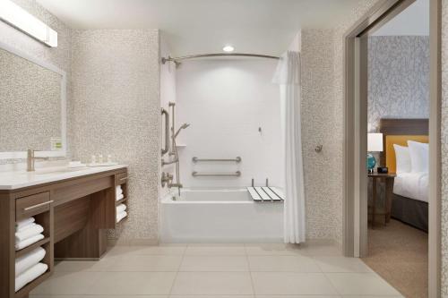 a bathroom with a tub and a sink and a shower at Home2 Suites By Hilton Ephrata in Ephrata