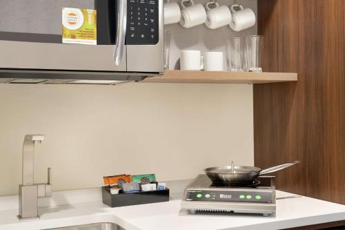 a kitchen with a stove with a pot on it at Home2 Suites By Hilton Ephrata in Ephrata