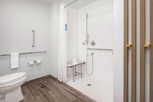 a white bathroom with a toilet and a shower at Hampton Inn by Hilton Verona at Turning Stone in Verona