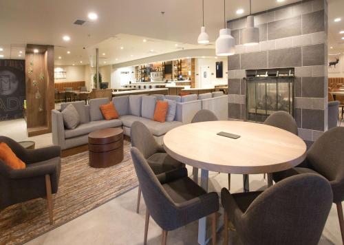 a living room with a table and chairs and a couch at Doubletree By Hilton Chico, Ca in Chico