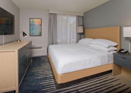 a hotel room with a large bed and a television at Doubletree By Hilton Chico, Ca in Chico