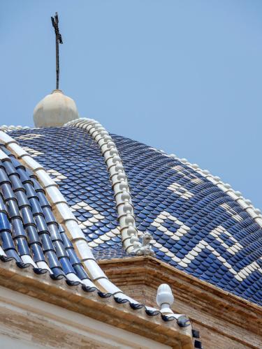 a blue tile roof on top of a building at Hostal Perla Blanca Altea in Altea