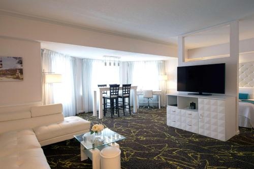 a living room with a white couch and a television at The Roslyn, Tapestry Collection by Hilton in Roslyn
