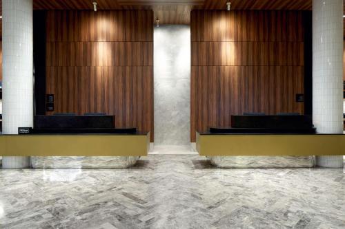 a lobby with wooden stalls in a building at Homewood Suites By Hilton Montreal Midtown in Montréal