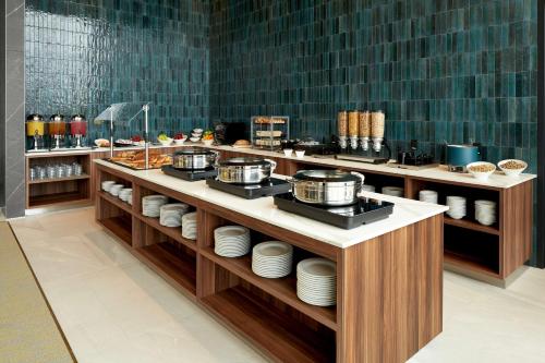 a restaurant with a buffet with dishes on display at Homewood Suites By Hilton Montreal Midtown in Montréal