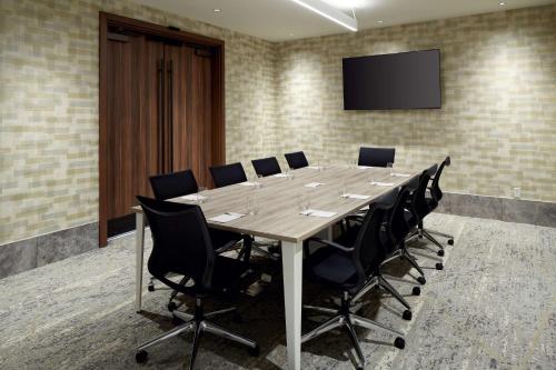 a large conference room with a long table and chairs at Homewood Suites By Hilton Montreal Midtown in Montréal