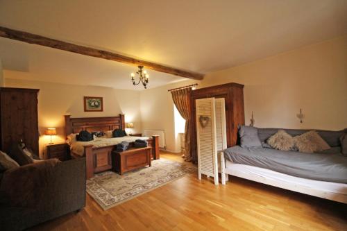 a bedroom with two beds and a desk in it at Hamlet retreat in Ladignac-le-Long