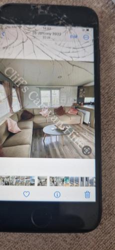 a cell phone taking a picture of a living room at Cliffs caravan hire in Gisburn