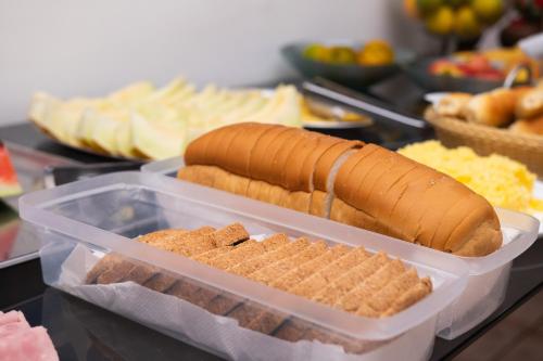 a plastic container with hot dogs and crackers on a table at Guajará Palace Hotel in Porto Velho