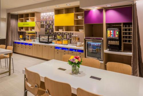 a dining room with a table and chairs at Home2 Suites By Hilton Memphis East / Germantown, Tn in Memphis