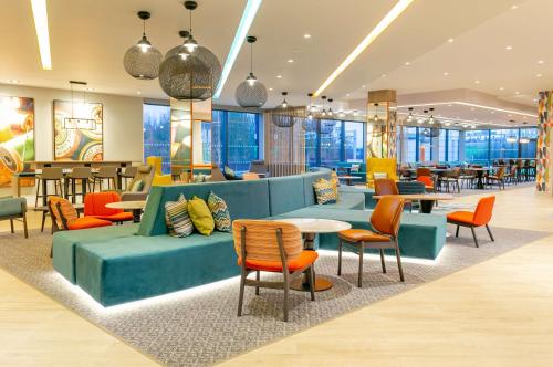 a restaurant with colorful furniture and tables and chairs at Hampton By Hilton Blackburn in Blackburn