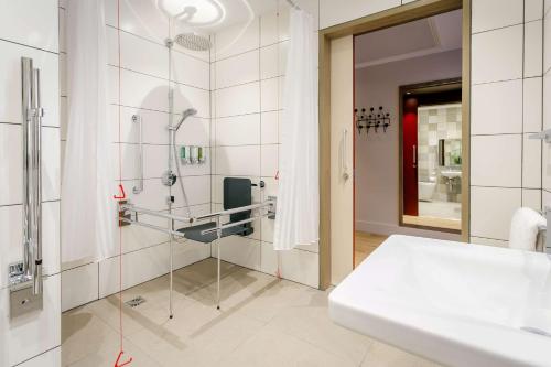 a bathroom with a shower and a sink at Hampton By Hilton Blackburn in Blackburn