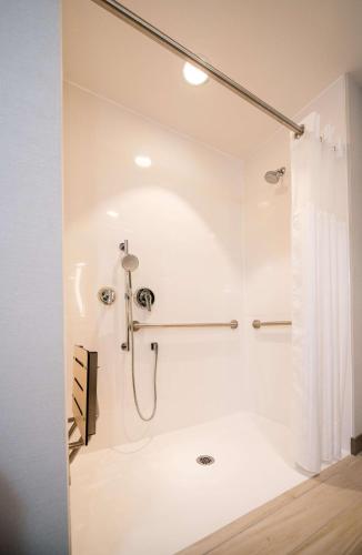 a bathroom with a shower with a shower curtain at Hilton Garden Inn Moncton Downtown, Nb in Moncton