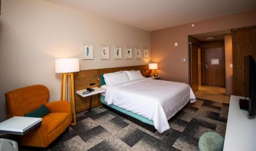 a hotel room with a bed and a chair at Hilton Garden Inn Moncton Downtown, Nb in Moncton
