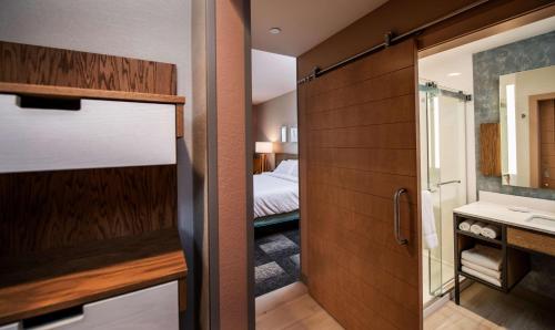 a bathroom with a shower and a bedroom with a bed at Hilton Garden Inn Moncton Downtown, Nb in Moncton